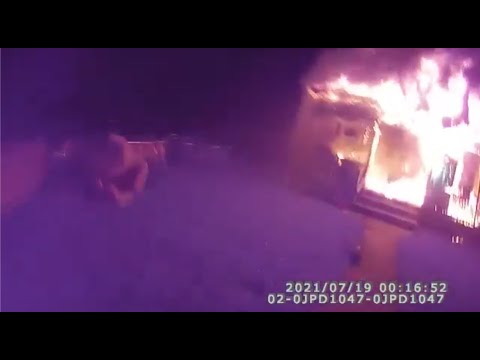 A Police Officer Catches People Jumping From a Burning House
